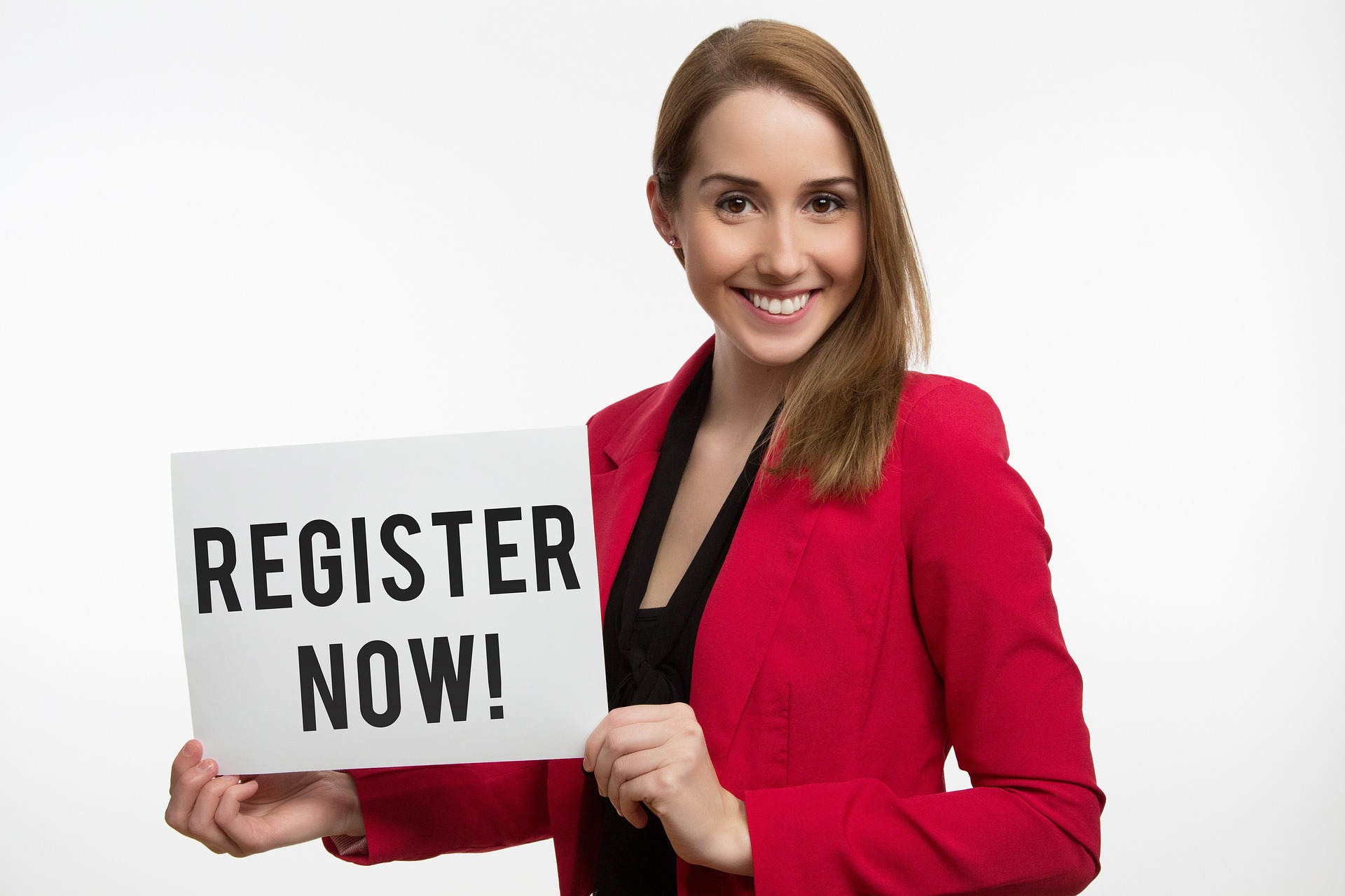 woman holding a register now sign